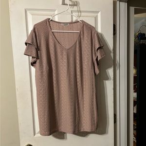 Blush colored women’s plus short sleeve blouse, ruffle sleeves.